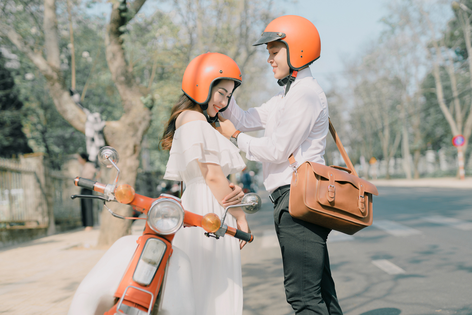 A Couple Wearing Orange Helmets