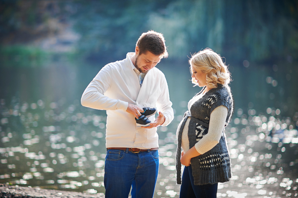 Pregnant Couple Looking at Baby's Shoes