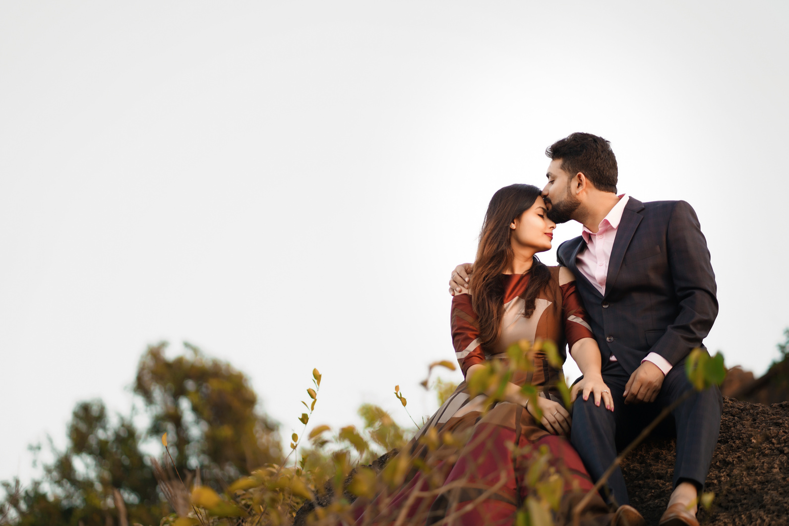 Photo of a Man Kissing a Woman on Forehead